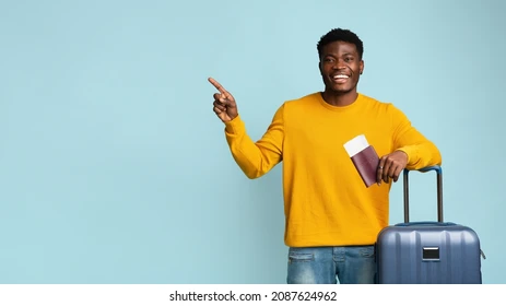 Happy traveler holding passport and flight tickets