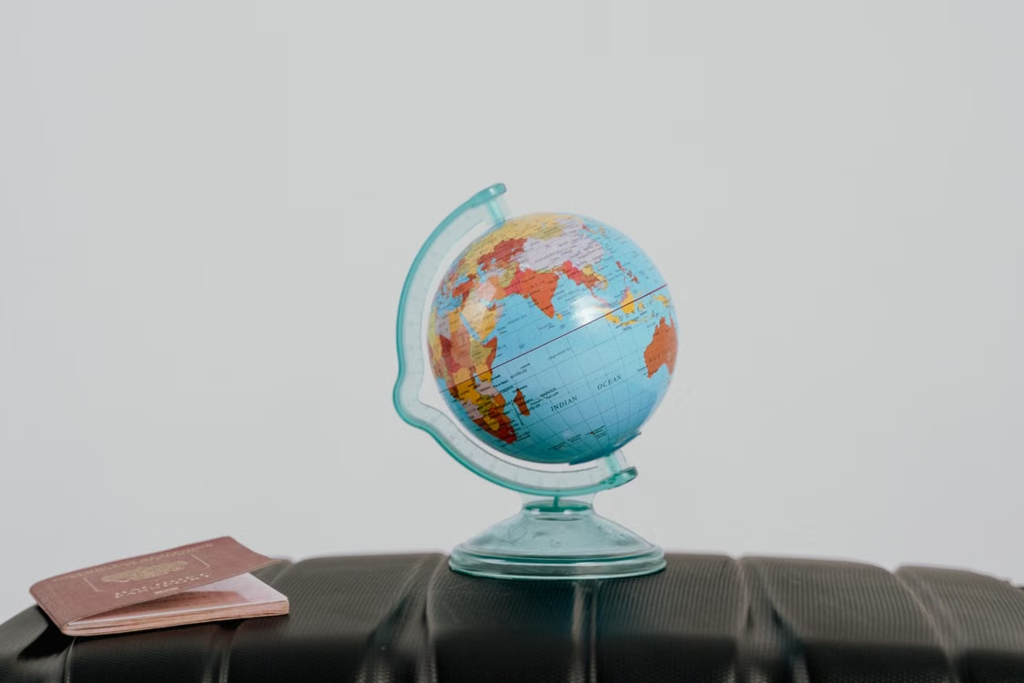Globe and passport on a suitcase